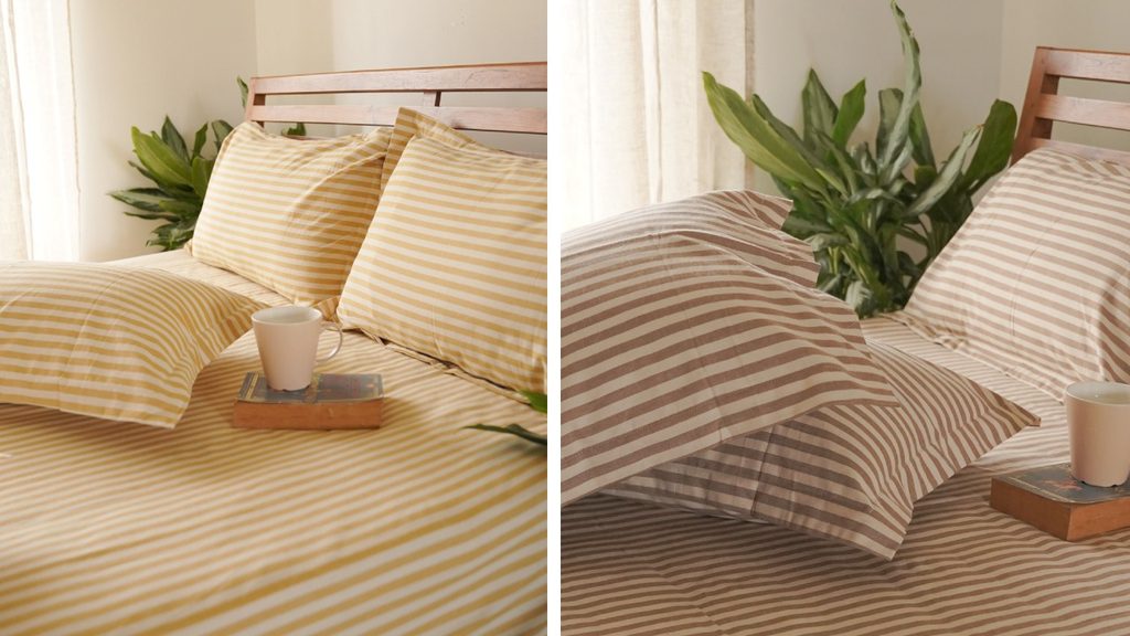 Morning Stripe cotton bedsheet with evenly spaced stripes on a beige base and matching pillow covers