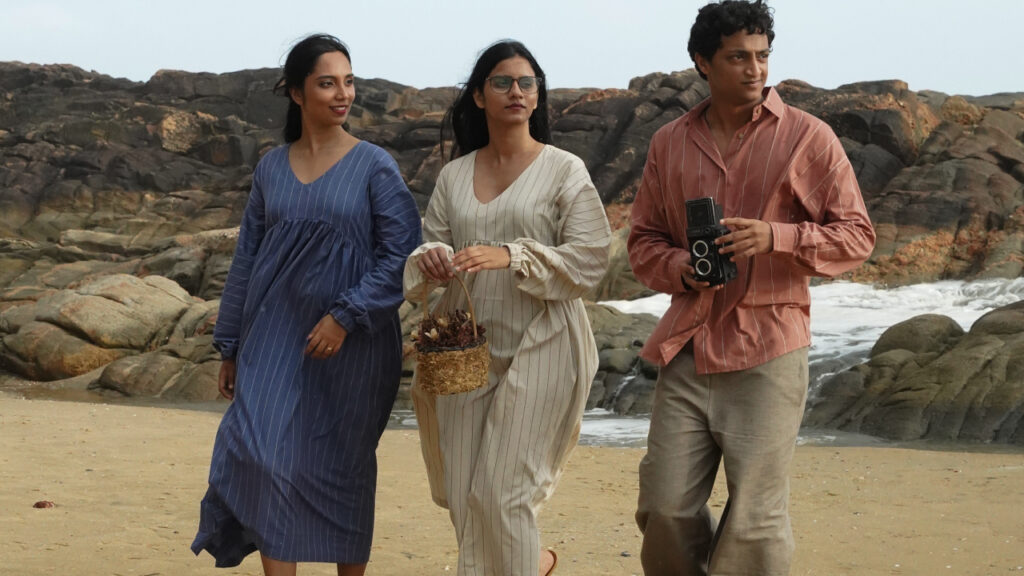 Men and women in Thoppiawear cotton and linen clothing walking on a beach